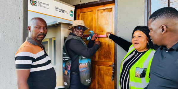 MEC Molapisi hands over a house to a beneficiary